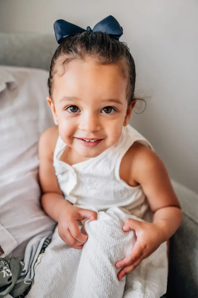 Sibling during baby photoshoot at home in Irmo SC