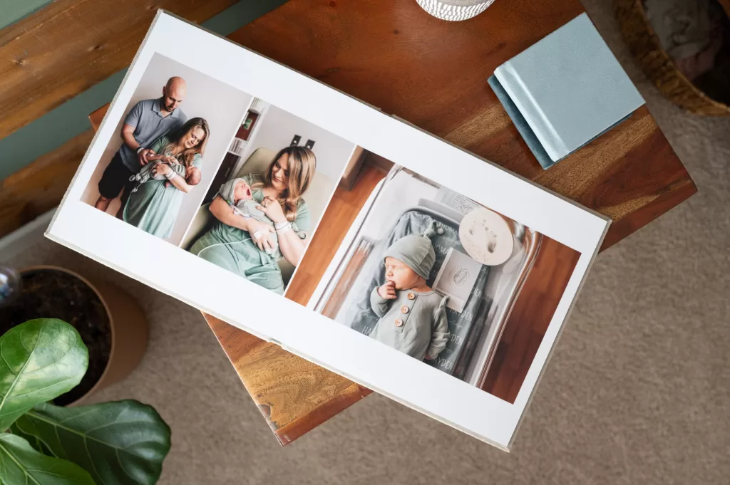 Photo ablum on a nightstand featuring a newborn session in a hospital in Lexington Medical Center