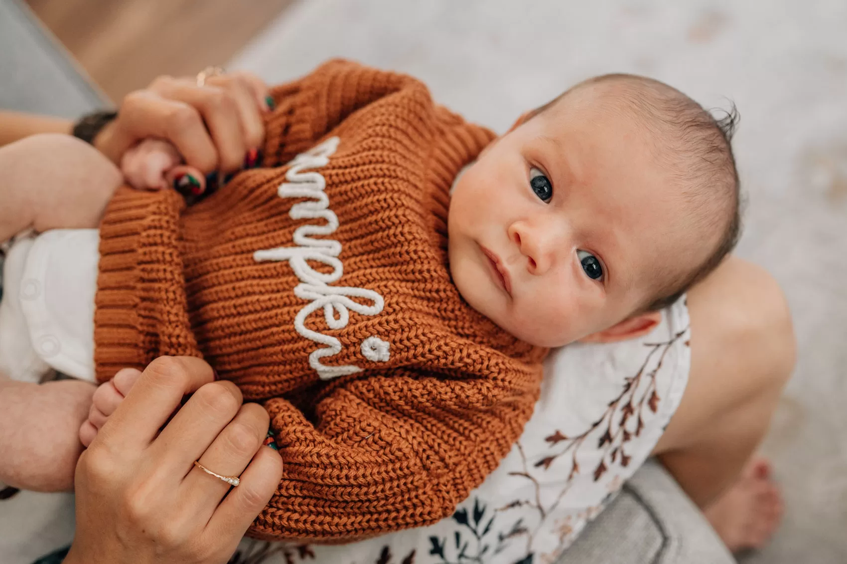 3 week old baby boy wearing a brown sweater during home newborn session in Columbia SC