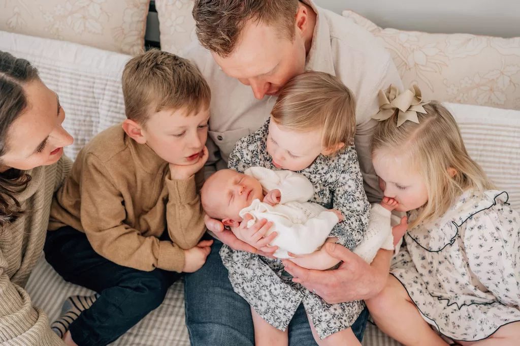 A family of six during a in-home newborn photo session.